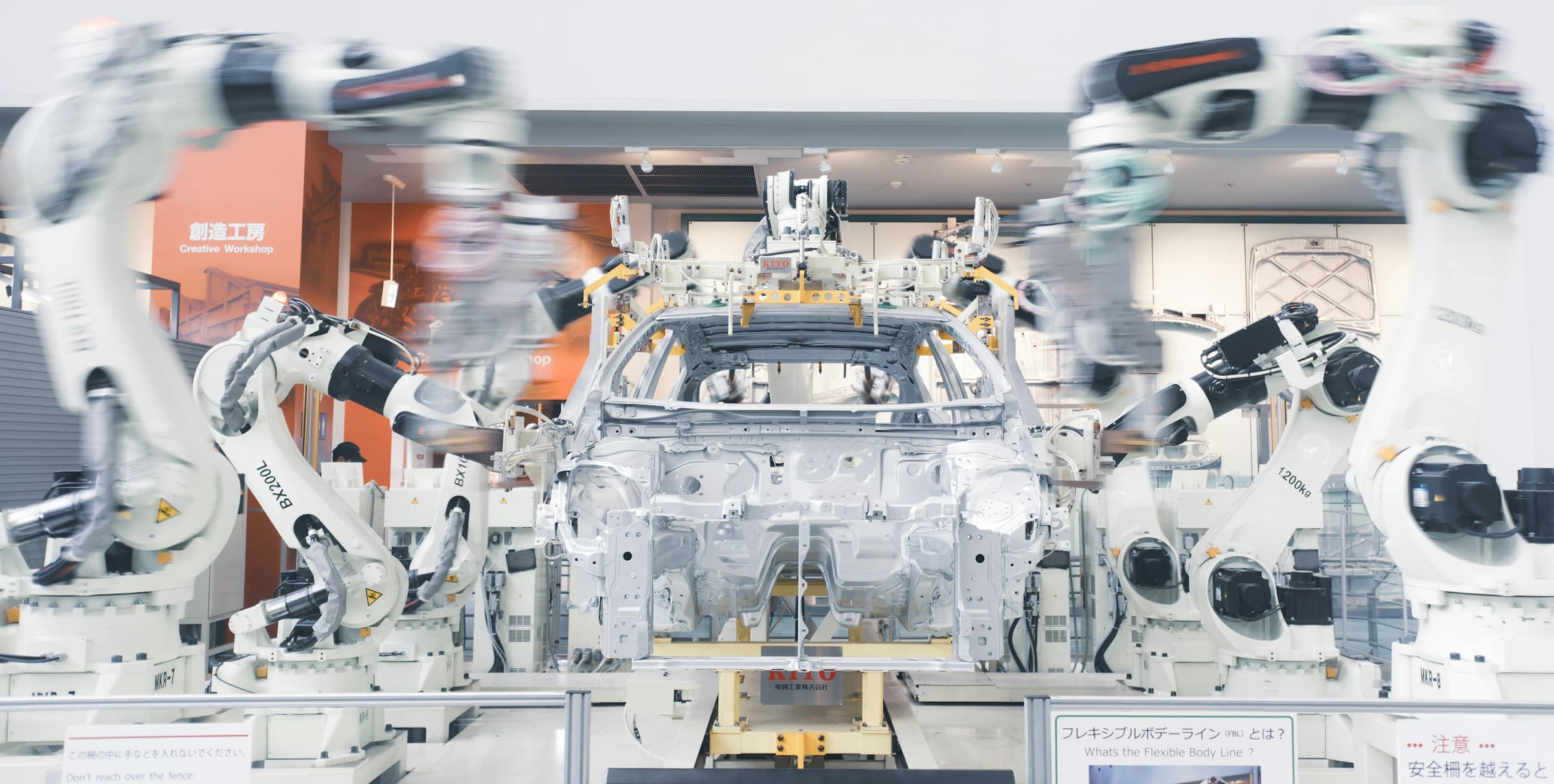 Robotic arms working around an automotive assembly line